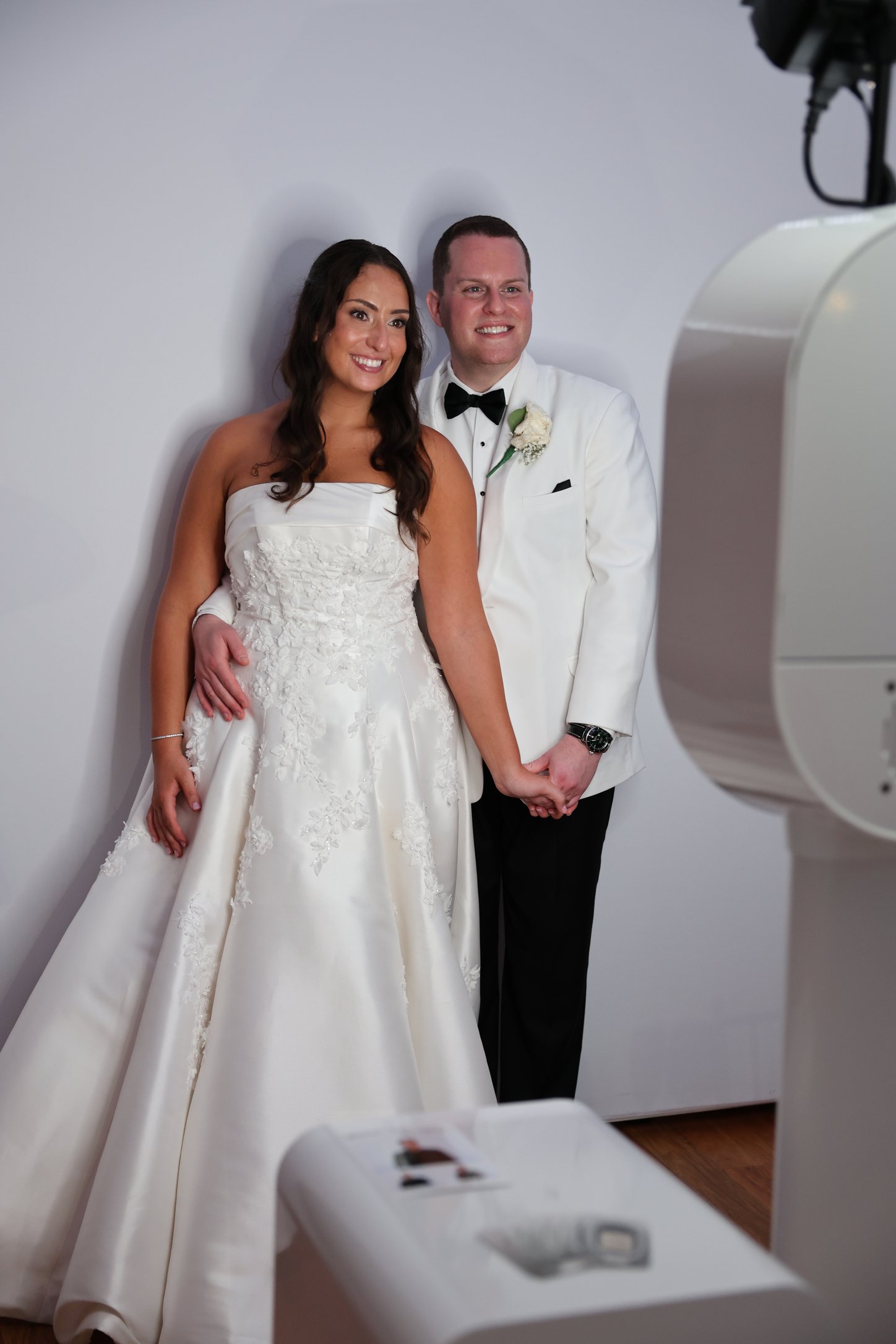 A couple beside a white photo booth