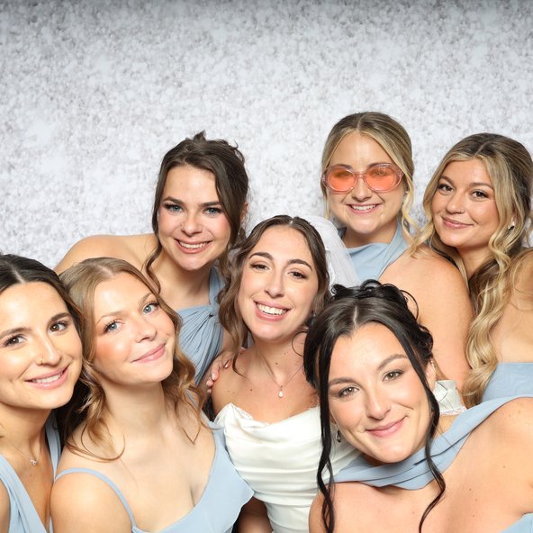 A group of friends in pastel dresses posing together