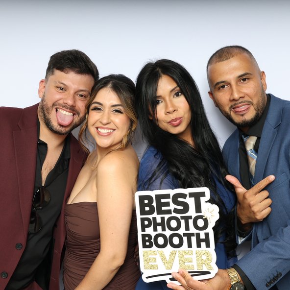Friends holding a Best Photo Booth Ever sign