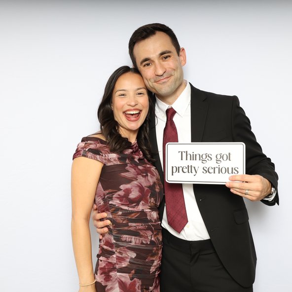 A couple holding a sign that reads Things got pretty serious